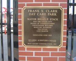 Bronze plaque #11 cast bronze plaque, double line flat band border with notched corners, brown background, leatherette texture, concealed stud mounted on brick.