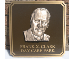 Photo #6 Cast bronze plaque with a notched double line border, brown background and a bronze bas-relief head.