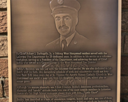 Photo #60 Bronze plaque with a flat band border and oxidized color, Studs on back for mounting.