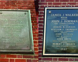 Bronze plaque #13 refinished cast bronze plaque, flat band beveled border, dark brown background, no texture, screws through face mounted on brick.