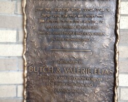This 18x24 bronze plaque is designed with a custom sculpted border, featuring both Hebrew and English text. It includes a prayer for the State of Israel, with a dedication by Butch and Valerie Elias to their children and grandchildren. The plaque's artistic texture and intricate design make it a unique and meaningful tribute, ideal for religious or commemorative spaces. Crafted with high-quality materials, it offers a timeless and lasting display. Sephardic Temple Sculpted Bronze Plaque