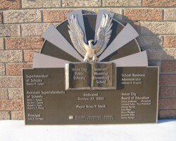 Bronze plaque #16  bronze plaque, flat band border with arched top, brown background, leatherette texture, sculpted book and eagle, concealed stud mount.